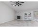 Bright living room with brick fireplace, ceiling fan, and view of the backyard pool at 676 W Shawnee Dr, Chandler, AZ 85225
