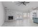 Bright living room with a fireplace, updated tile floors, and double doors to the backyard at 676 W Shawnee Dr, Chandler, AZ 85225