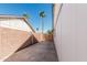 View of the concrete side yard and brick fence at 676 W Shawnee Dr, Chandler, AZ 85225