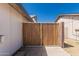 A wooden gate with white painted trim at 676 W Shawnee Dr, Chandler, AZ 85225