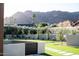Lush backyard featuring well-manicured grass, elegant landscaping, and scenic mountain views at 7215 N Black Rock Trl, Paradise Valley, AZ 85253