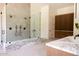 Bathroom featuring a glass-enclosed shower and custom wood cabinetry at 7215 N Black Rock Trl, Paradise Valley, AZ 85253
