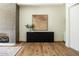 Bedroom with hardwood floors, a modern fireplace, and a large black storage cabinet at 7215 N Black Rock Trl, Paradise Valley, AZ 85253