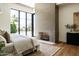 Bright bedroom featuring a stone fireplace, large windows, and hardwood floors at 7215 N Black Rock Trl, Paradise Valley, AZ 85253