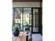 Bright dining area with modern black-framed glass windows providing ample natural light and views of the greenery at 7215 N Black Rock Trl, Paradise Valley, AZ 85253