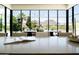 Bright dining area showcasing floor-to-ceiling windows with picturesque mountain scenery at 7215 N Black Rock Trl, Paradise Valley, AZ 85253