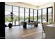 Elegant dining room featuring floor-to-ceiling windows with scenic views and hardwood floors at 7215 N Black Rock Trl, Paradise Valley, AZ 85253