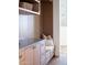 Hallway features wood-paneled wall with built-in bench, drawer storage, and decorative pillows at 7215 N Black Rock Trl, Paradise Valley, AZ 85253