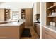 Kitchen featuring wood cabinets, marble backsplash, a large island, and modern appliances at 7215 N Black Rock Trl, Paradise Valley, AZ 85253