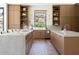 Expansive kitchen area boasting marble countertops, wood cabinets, and a serene view from the bright, natural light at 7215 N Black Rock Trl, Paradise Valley, AZ 85253