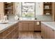 Well-designed kitchen features a window view, custom cabinets, and marble countertops at 7215 N Black Rock Trl, Paradise Valley, AZ 85253