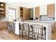 Spacious kitchen featuring a large island, breakfast bar, custom cabinets and open shelving at 7215 N Black Rock Trl, Paradise Valley, AZ 85253