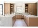 Well-lit kitchen with custom wood cabinetry, marble countertops, and stainless steel fixtures at 7215 N Black Rock Trl, Paradise Valley, AZ 85253