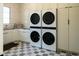 Laundry room featuring stacked white LG washer and dryer units and gray tile flooring at 7215 N Black Rock Trl, Paradise Valley, AZ 85253