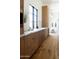 Modern laundry room with wood cabinets, marble countertops, and decor accents at 7215 N Black Rock Trl, Paradise Valley, AZ 85253