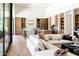 Open-concept kitchen and living space with light hardwood floors, neutral furniture, and expansive windows at 7215 N Black Rock Trl, Paradise Valley, AZ 85253