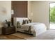 Calm main bedroom featuring a cozy bed, stylish nightstand, and large windows, creating a peaceful retreat at 7215 N Black Rock Trl, Paradise Valley, AZ 85253