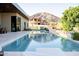 Inviting backyard pool featuring mountain views, lush landscaping, with serene, luxurious, modern design at 7215 N Black Rock Trl, Paradise Valley, AZ 85253