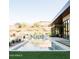 Backyard pool area with desert landscaping, built-in grill, and stunning mountain views in the background at 7215 N Black Rock Trl, Paradise Valley, AZ 85253