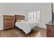 Bedroom with a bed, dresser, and shuttered windows at 7536 W Sequoia Dr, Glendale, AZ 85308