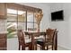 A cozy dining area beside a large window offering natural light, complete with a table and chairs at 7536 W Sequoia Dr, Glendale, AZ 85308