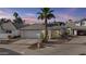 Charming home featuring desert landscaping, a palm tree, and a two-car garage at 7536 W Sequoia Dr, Glendale, AZ 85308