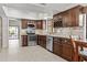 Modern kitchen featuring stainless steel appliances, granite countertops, and stylish dark wood cabinetry at 7536 W Sequoia Dr, Glendale, AZ 85308
