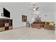 Bright living room with tile floors, ceiling fan, comfortable seating, and natural light at 7536 W Sequoia Dr, Glendale, AZ 85308