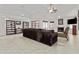 Inviting living room featuring a cozy fireplace, comfortable sofa, and tiled flooring at 7536 W Sequoia Dr, Glendale, AZ 85308