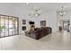 Spacious living room with a vaulted ceiling, tile flooring, and a cozy fireplace at 7536 W Sequoia Dr, Glendale, AZ 85308