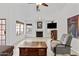Bright living room with tiled floors, a fireplace, and comfortable seating area at 7536 W Sequoia Dr, Glendale, AZ 85308