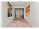 Tiled patio with secure iron gate, artwork, and view of pool at 7536 W Sequoia Dr, Glendale, AZ 85308