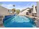 Backyard pool with blue tile and palm trees at 7536 W Sequoia Dr, Glendale, AZ 85308