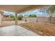 Backyard with covered patio, providing shade and a fire pit perfect for relaxing or entertaining at 7716 W Pueblo Ave, Phoenix, AZ 85043