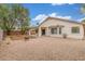 Well maintained backyard with covered patio, providing shade, brick fire pit, and gravel landscaping at 7716 W Pueblo Ave, Phoenix, AZ 85043