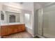 Well-lit bathroom offering double sinks, soaking tub, and glass-enclosed shower at 7716 W Pueblo Ave, Phoenix, AZ 85043