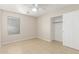 Neutral toned bedroom with large window, ceiling fan, and large closet space at 7716 W Pueblo Ave, Phoenix, AZ 85043