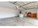Spacious two-car garage with laundry area and extra storage space for tools and equipment at 7716 W Pueblo Ave, Phoenix, AZ 85043