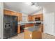 Well-equipped kitchen features an island, black appliances, and ample counter space at 7716 W Pueblo Ave, Phoenix, AZ 85043