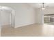 Spacious living room offers tile floors, ceiling fan, and sliding door to backyard at 7716 W Pueblo Ave, Phoenix, AZ 85043