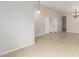 Spacious living area featuring neutral tile flooring, base molding, and an open layout, perfect for entertaining at 7716 W Pueblo Ave, Phoenix, AZ 85043