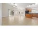 Large living room with view to kitchen and sliding glass door to backyard at 7716 W Pueblo Ave, Phoenix, AZ 85043