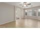 Comfortable main bedroom features tile flooring, ceiling fan, and view to bathroom at 7716 W Pueblo Ave, Phoenix, AZ 85043