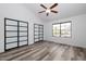 Spacious bedroom with wood-look floors, lots of natural light, and ample closet space at 7801 N 44Th Dr # 1003, Glendale, AZ 85301