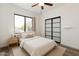 Bright bedroom features a ceiling fan, closet with sliding panel doors and a sun-filled window at 7801 N 44Th Dr # 1003, Glendale, AZ 85301