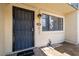 Front entrance features a secure metal door, a window with trim and landscaping at 7801 N 44Th Dr # 1003, Glendale, AZ 85301