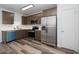 Updated kitchen with stainless steel appliances, white countertops, and sleek wood-look floors at 7801 N 44Th Dr # 1003, Glendale, AZ 85301