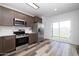 Updated kitchen with stainless appliances, modern countertops and wood-look floors, plus sliding glass door at 7801 N 44Th Dr # 1003, Glendale, AZ 85301