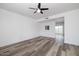 Open living room boasts wood-look floors and a ceiling fan, creating a comfortable space at 7801 N 44Th Dr # 1003, Glendale, AZ 85301