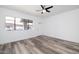 Bright living room with wood-look floors, ceiling fan, and large window for natural light at 7801 N 44Th Dr # 1003, Glendale, AZ 85301